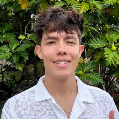 Elijah Ching, man posing in front of tropical background